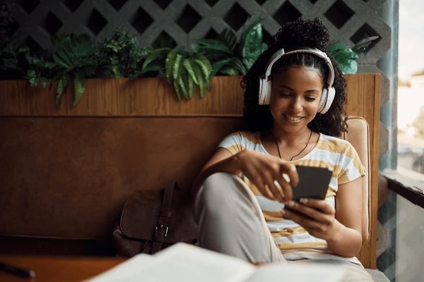 Relaxed student listening to music with headphones