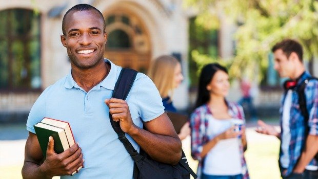 Smiling university students together on campus